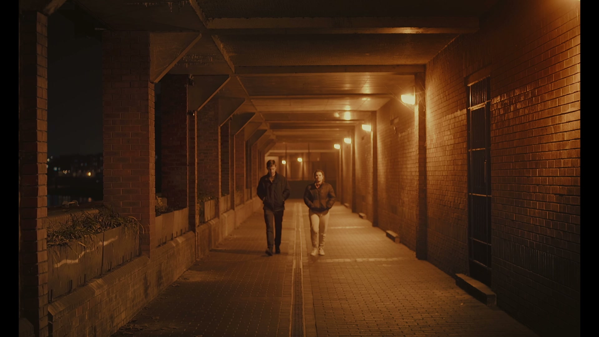 Still 02 · sodium-lit tunnel under bridge